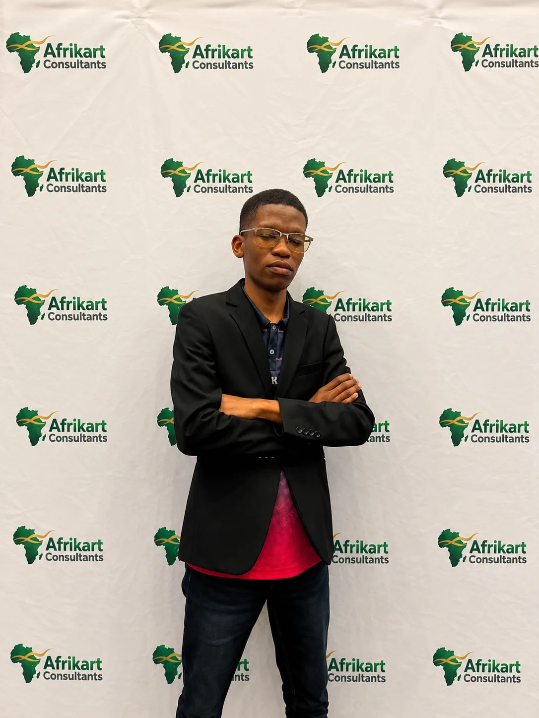 Afrikart Consultants founder in front of a branded media wall